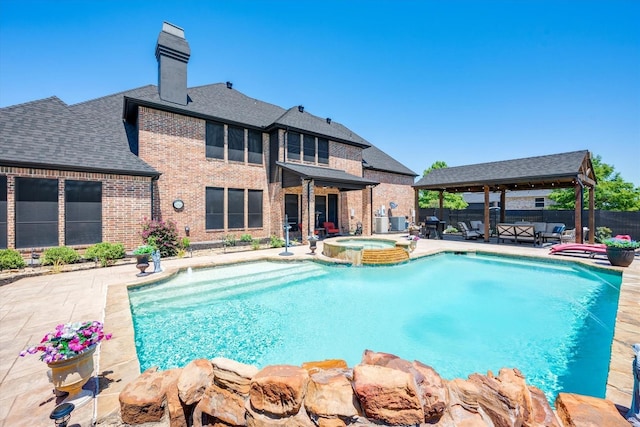 view of pool with a gazebo, a patio area, a pool with connected hot tub, and fence