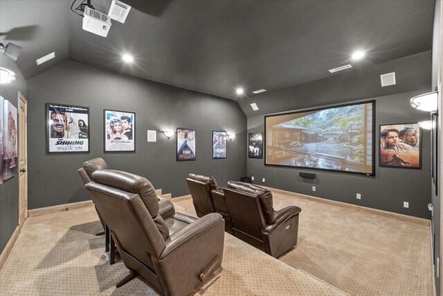 home theater room featuring baseboards, carpet floors, visible vents, and vaulted ceiling