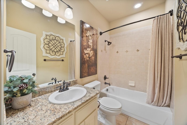 full bath featuring tile patterned floors, toilet, vanity, and shower / bath combo