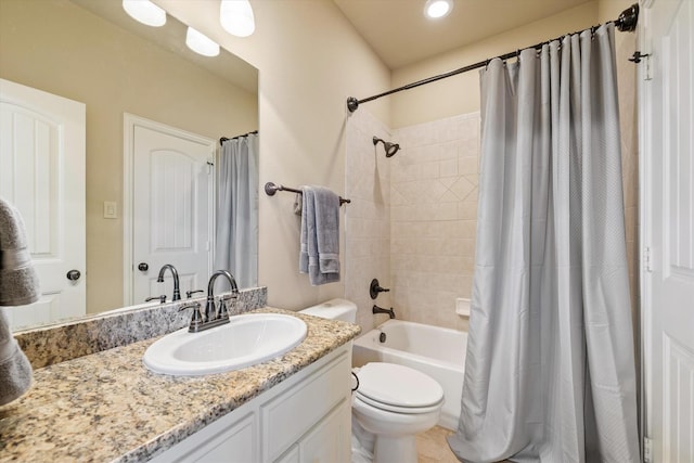 bathroom featuring vanity, toilet, and shower / bath combo with shower curtain