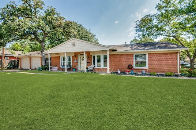 single story home with brick siding, a garage, and a front yard