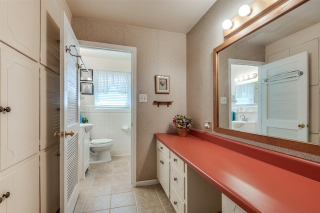 bathroom featuring tile patterned flooring, toilet, and vanity