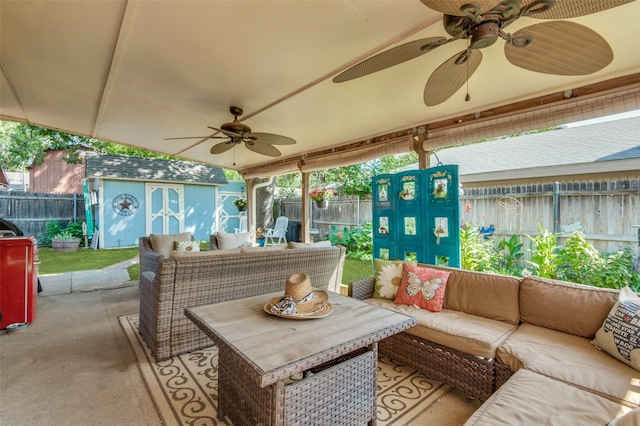 view of patio / terrace with an outbuilding, an outdoor living space, a storage unit, and a fenced backyard