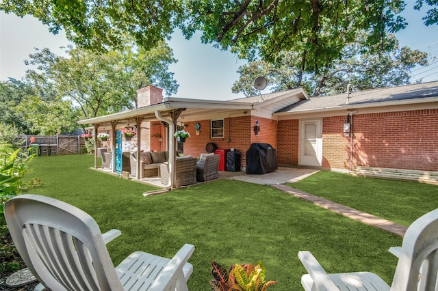 rear view of property with an outdoor living space, a patio area, brick siding, and a chimney