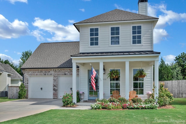 view of front of home with brick siding, a shingled roof, a chimney, driveway, and a standing seam roof