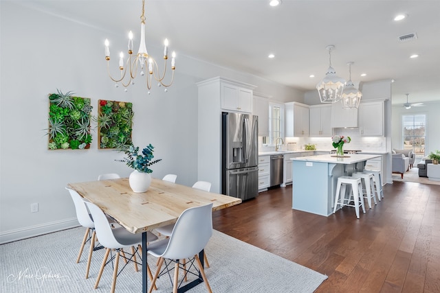 dining area featuring recessed lighting, visible vents, dark wood-style flooring, and baseboards