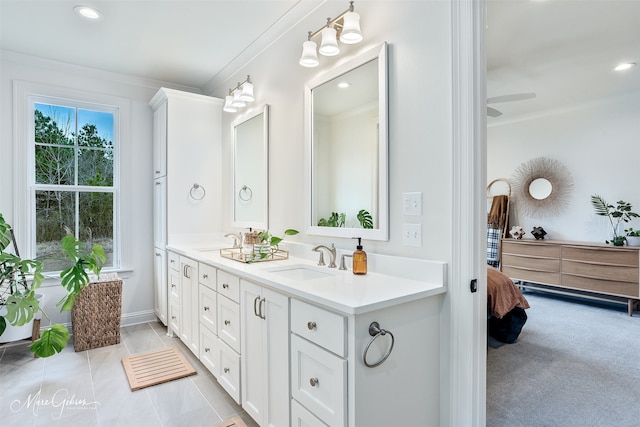 full bathroom featuring double vanity, ornamental molding, tile patterned floors, and a sink