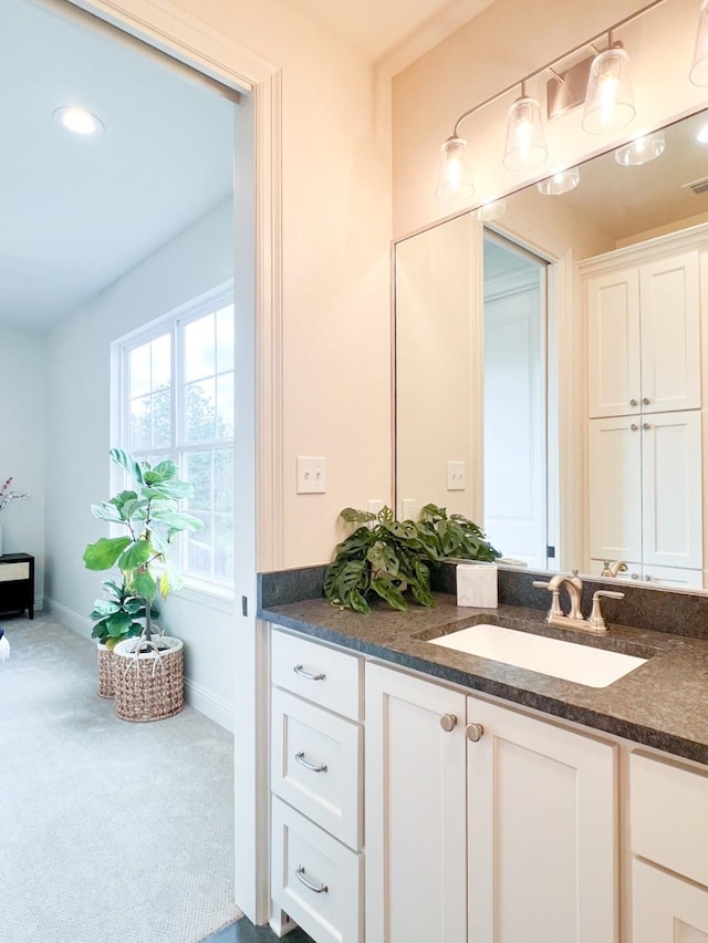 bathroom with vanity and baseboards