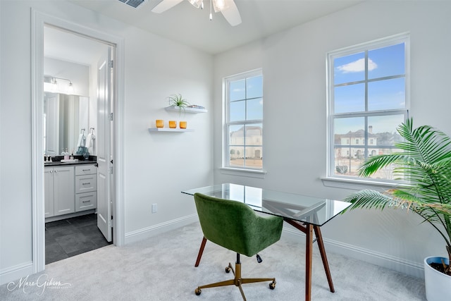 office space featuring baseboards, dark colored carpet, and ceiling fan