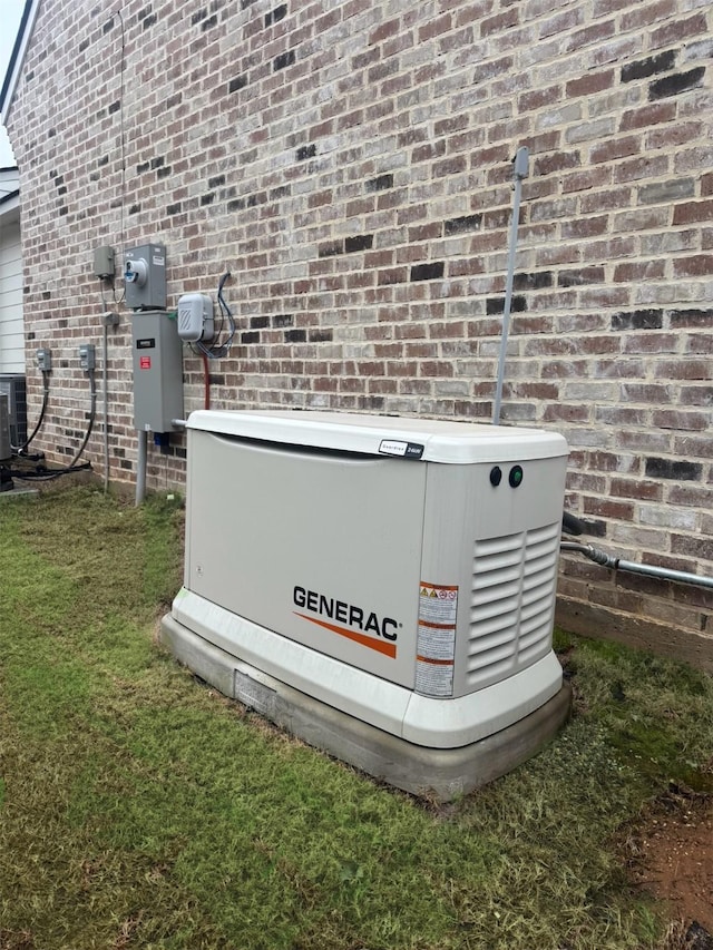 exterior details featuring a power unit, brick siding, central AC, and electric meter