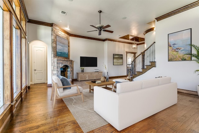 6620 Cedar Grove Dr, North Richland Hills, TX 76182 - living area with visible vents, wood finished floors, ceiling fan, crown molding, and a fireplace