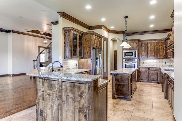 6620 Cedar Grove Dr, North Richland Hills, TX 76182 - kitchen featuring stainless steel appliances, backsplash, and ornamental molding