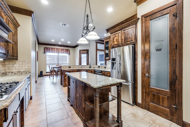 kitchen featuring tasteful backsplash, visible vents, ornamental molding, appliances with stainless steel finishes, and a peninsula