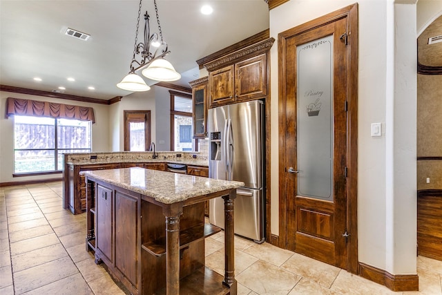 6620 Cedar Grove Dr, North Richland Hills, TX 76182 - kitchen with light stone counters, crown molding, stainless steel fridge with ice dispenser, visible vents, and dishwashing machine
