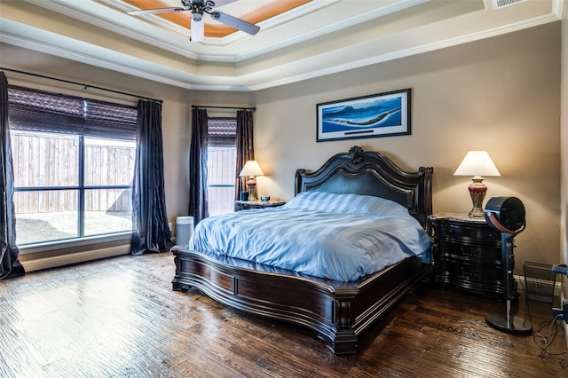 bedroom with visible vents, a ceiling fan, hardwood / wood-style flooring, crown molding, and a raised ceiling