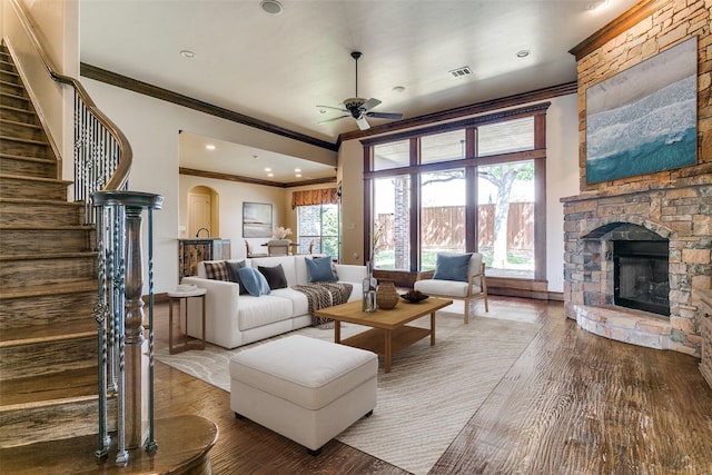 6620 Cedar Grove Dr, North Richland Hills, TX 76182 - living room with ornamental molding, a fireplace, a ceiling fan, stairway, and wood finished floors
