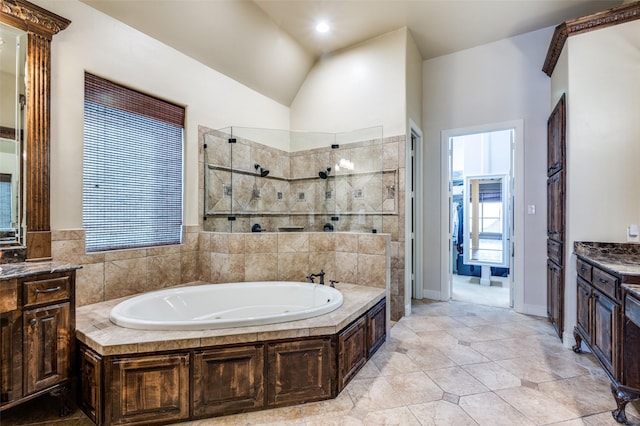 full bath featuring tile patterned floors, a walk in shower, lofted ceiling, a bath, and vanity