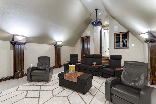 6620 Cedar Grove Dr, North Richland Hills, TX 76182 - home theater featuring light colored carpet, lofted ceiling, baseboards, and ornate columns