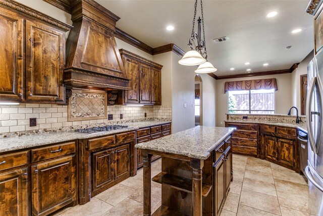 6620 Cedar Grove Dr, North Richland Hills, TX 76182 - kitchen with stainless steel gas stovetop, backsplash, crown molding, and custom range hood