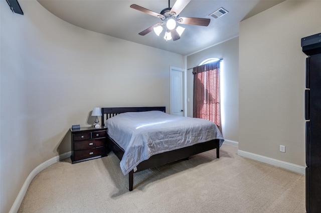 carpeted bedroom with baseboards, visible vents, and ceiling fan