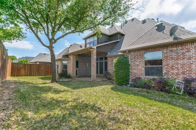 6620 Cedar Grove Dr, North Richland Hills, TX 76182 - back of house with a shingled roof, a fenced backyard, a yard, a patio, and brick siding