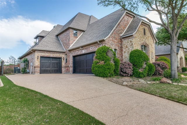 6620 Cedar Grove Dr, North Richland Hills, TX 76182 - view of home's exterior with driveway, fence, brick siding, an attached garage, and a shingled roof