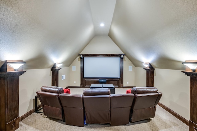 home theater with baseboards, light carpet, and vaulted ceiling