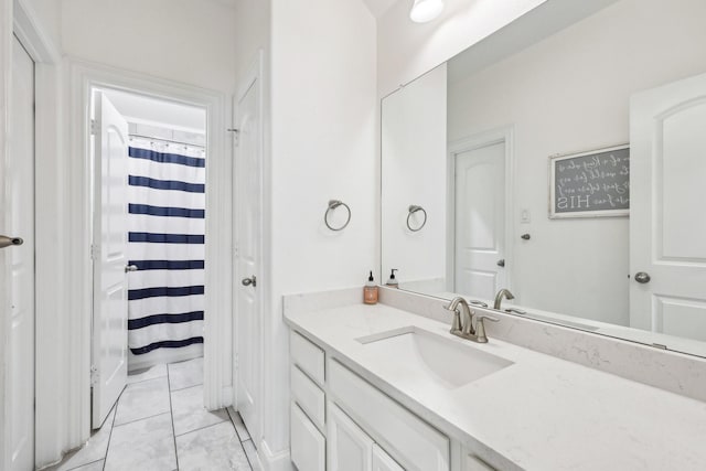 full bath with a shower with shower curtain, vanity, and tile patterned flooring