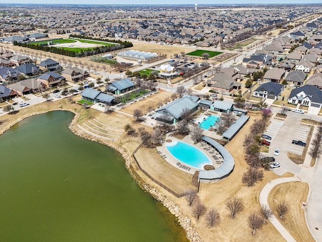 bird's eye view featuring a residential view and a water view