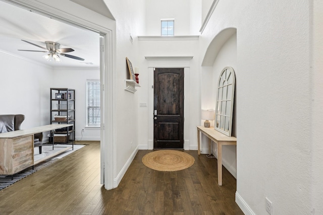 entryway with ornamental molding, baseboards, ceiling fan, and hardwood / wood-style flooring