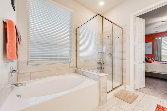 bathroom with a stall shower, ensuite bathroom, and a garden tub