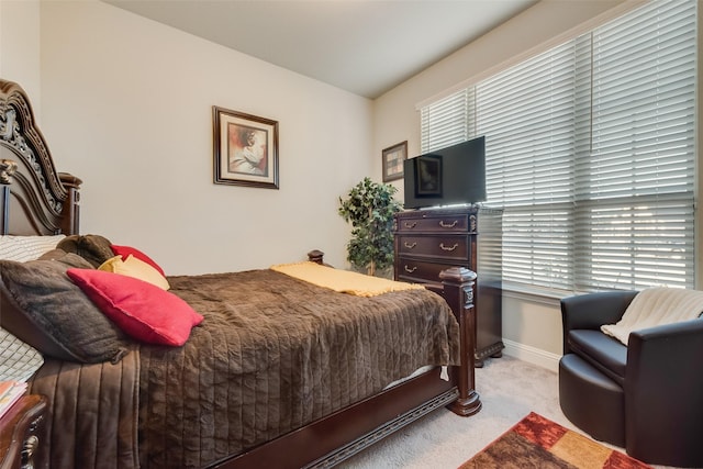 bedroom with carpet flooring and baseboards