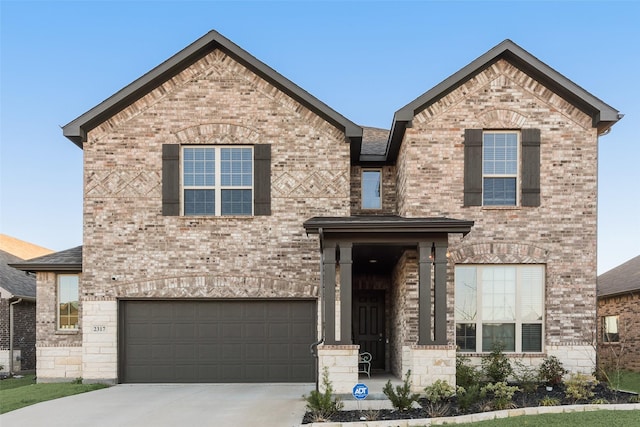 view of front facade with brick siding, stone siding, driveway, and a garage