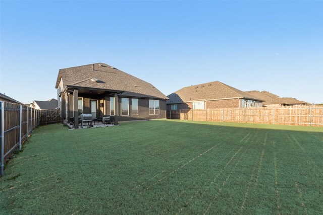 view of yard featuring a patio and a fenced backyard