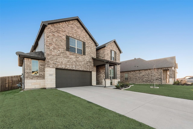 traditional-style home with fence, an attached garage, a front lawn, concrete driveway, and brick siding