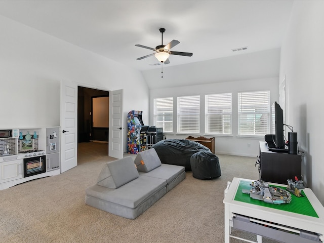 living room featuring lofted ceiling, carpet, visible vents, and ceiling fan