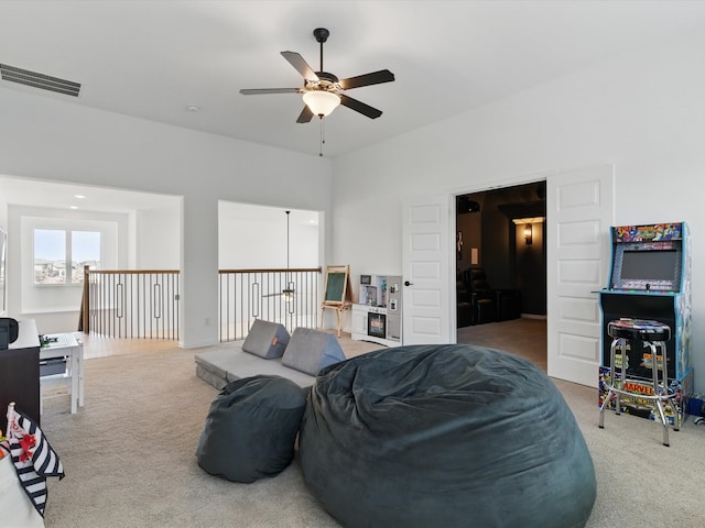 interior space featuring visible vents, carpet floors, and ceiling fan