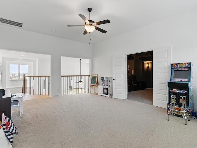 rec room featuring visible vents, carpet flooring, and a ceiling fan