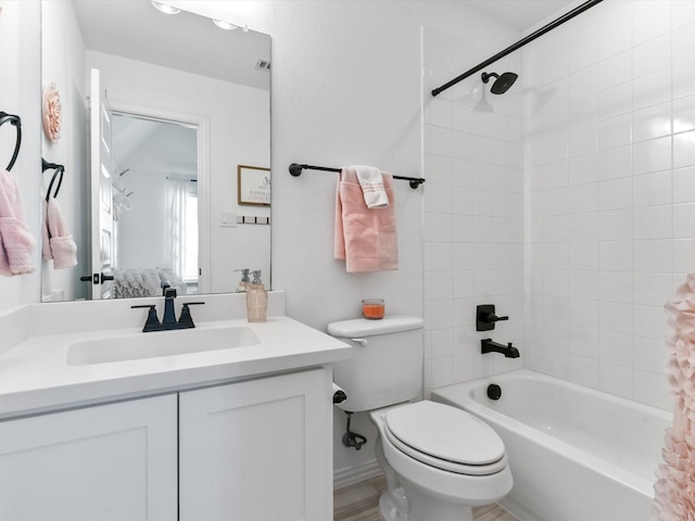 bathroom featuring vanity, toilet, and shower / bath combo