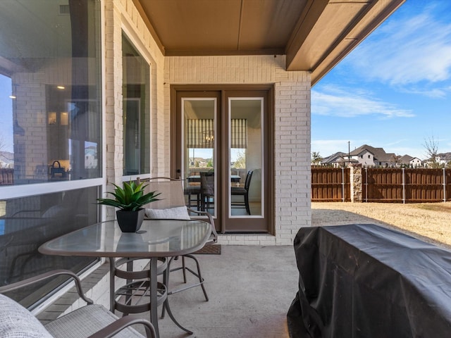 view of patio / terrace with outdoor dining space, fence, and grilling area