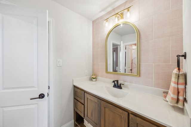 bathroom with vanity and tile walls