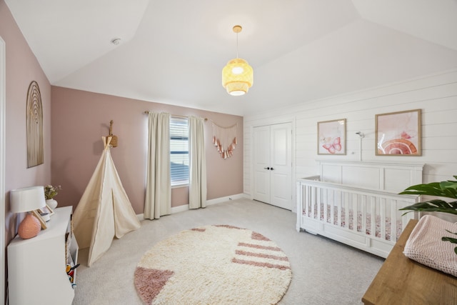 bedroom featuring baseboards, a closet, lofted ceiling, and carpet floors