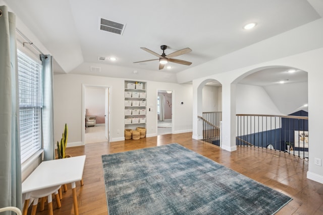 living area with recessed lighting, visible vents, baseboards, and wood finished floors