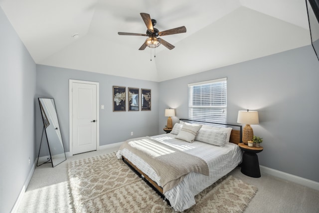 carpeted bedroom with ceiling fan, baseboards, and vaulted ceiling