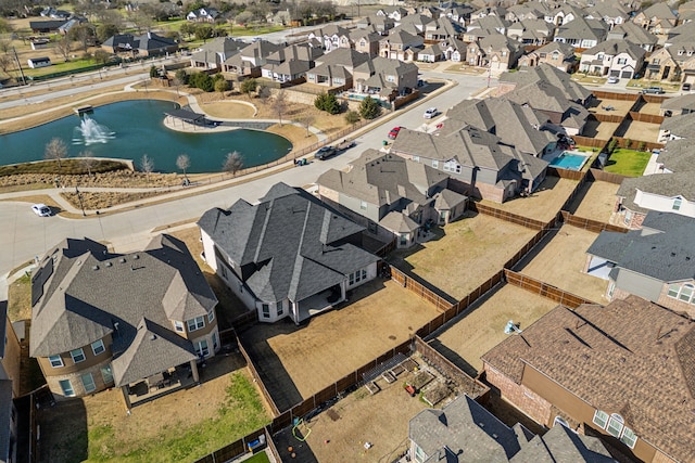 drone / aerial view featuring a residential view and a water view