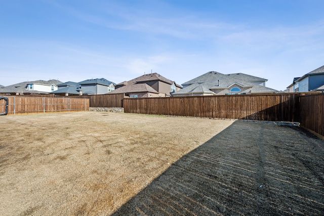 view of yard with a residential view and a fenced backyard