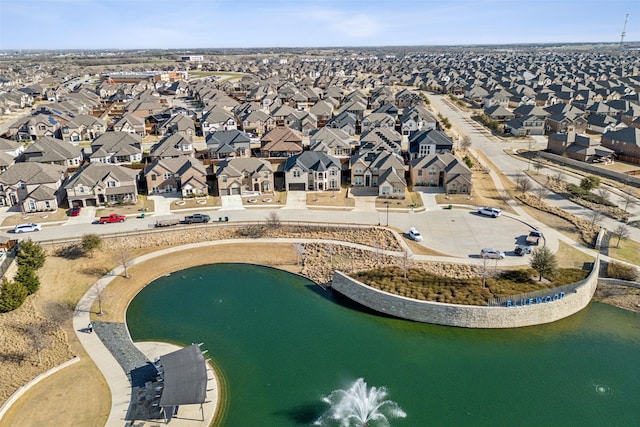 drone / aerial view with a residential view and a water view