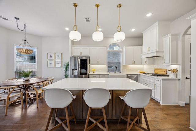 kitchen featuring plenty of natural light, visible vents, appliances with stainless steel finishes, and a sink