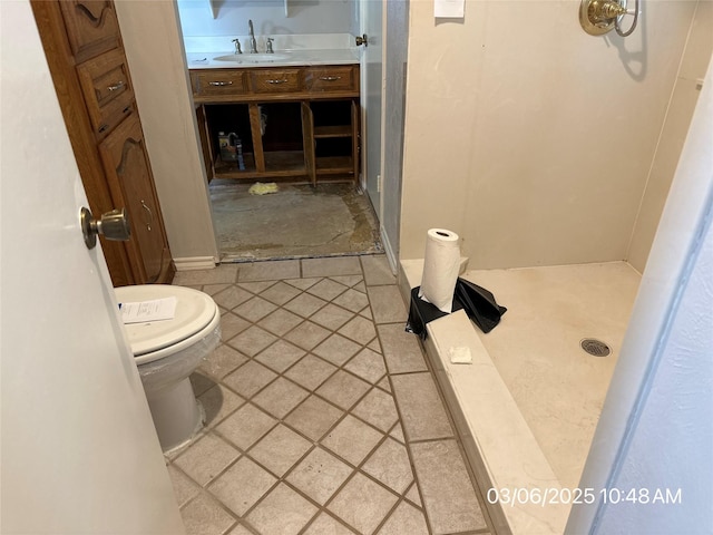 full bath with walk in shower, toilet, and a sink