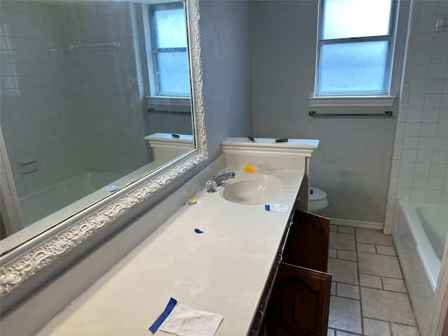 full bathroom featuring a wealth of natural light, toilet, vanity, and baseboards